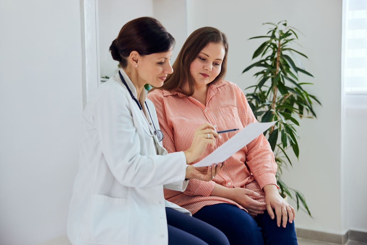 A doctor discusses information with a patient