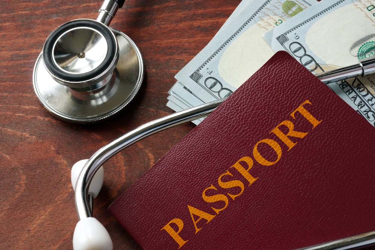 A stethoscope, a passport, and hundred-dollar bills representing medical tourism and cost savings with BMI’s priority pass.