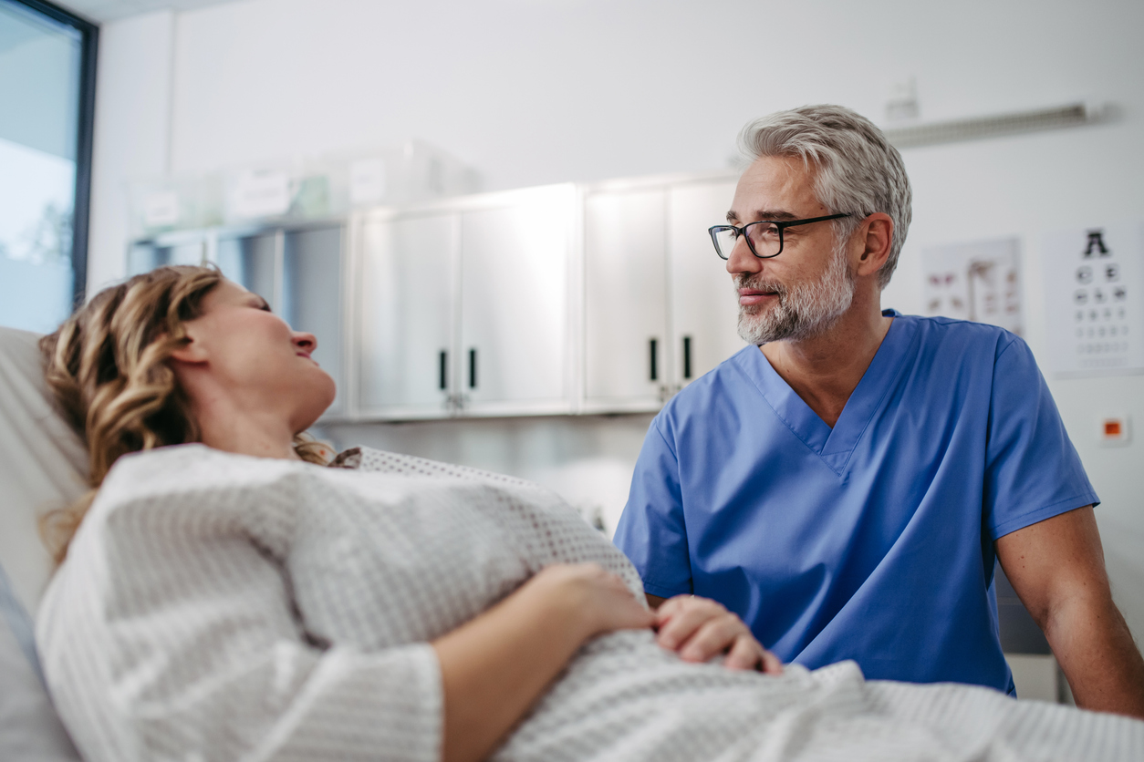 A doctor at a surgical center consulting with a patient before a general surgery.