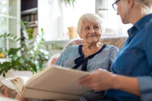 A woman sits with her mother to discuss their family health history.